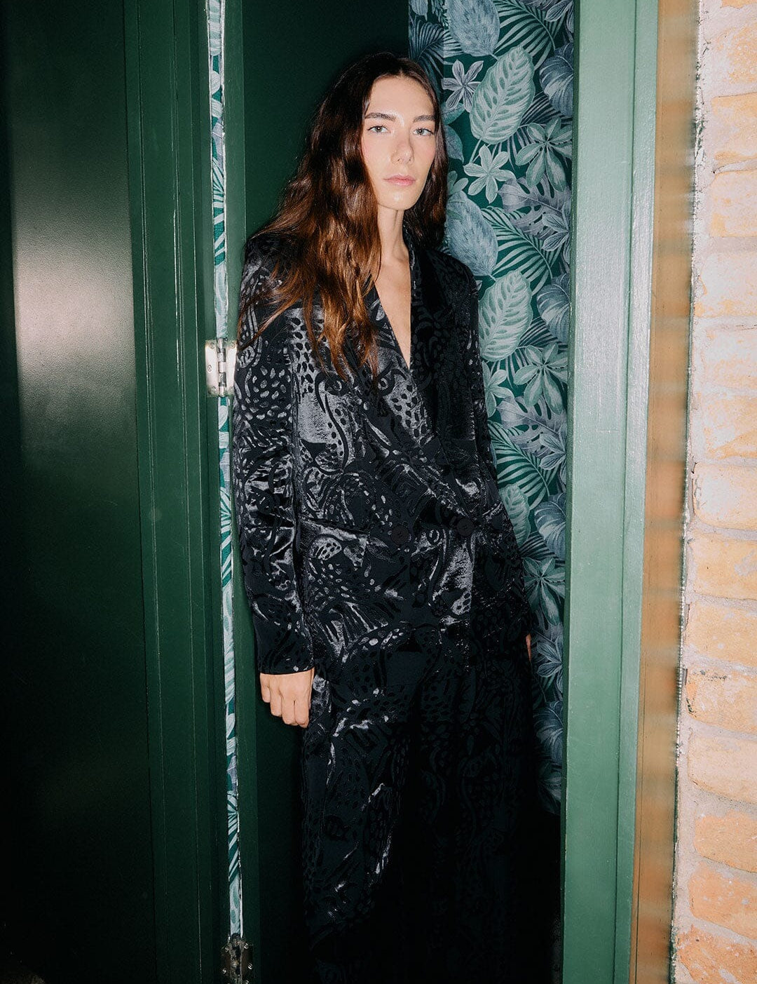 Woman wearing the Farm Rio black leopard blazer for an evening event look.