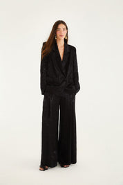 Model wearing the black leopard jacquard blazer by Farm Rio