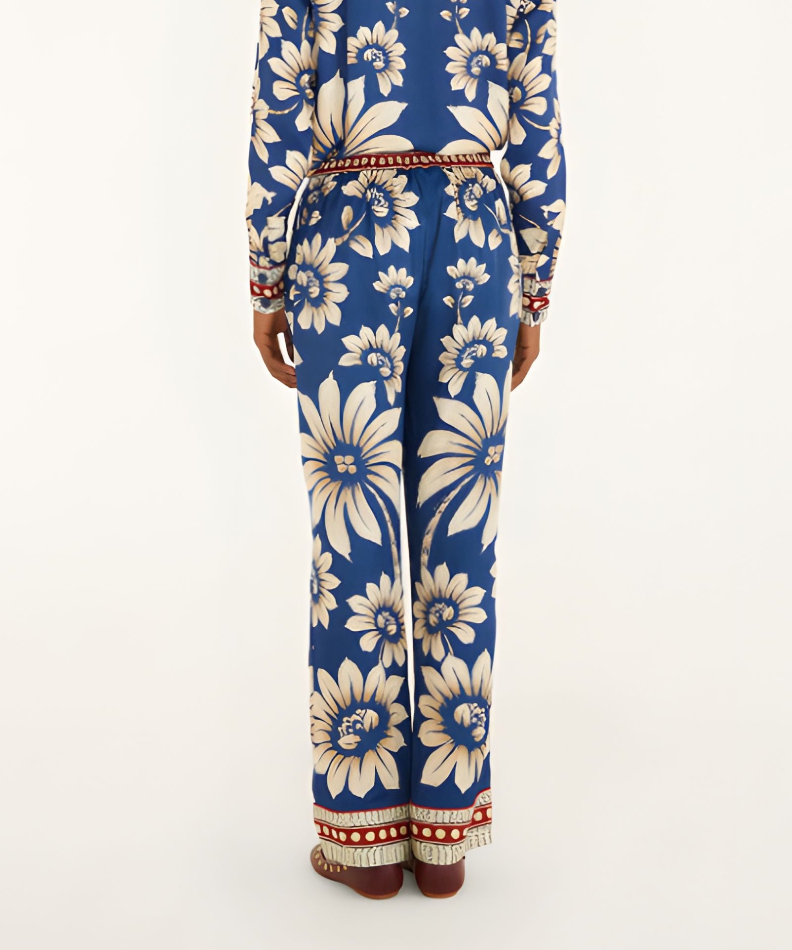 Back view of a model showcasing the fit and continuous blue botanical pattern of the Farm Rio wide-leg pajama pants.