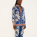 Side view of a model in a studio showcasing the relaxed, airy silhouette of the Farm Rio blue patterned pajama shirt.