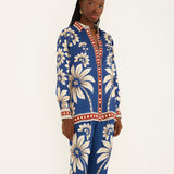 Side view of a model in a studio showcasing the relaxed, airy silhouette of the Farm Rio blue patterned pajama shirt.