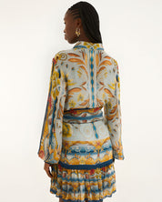 Back view of a model in a studio showcasing the relaxed fit and vibrant mosaic print of the Farm Rio mini dress.