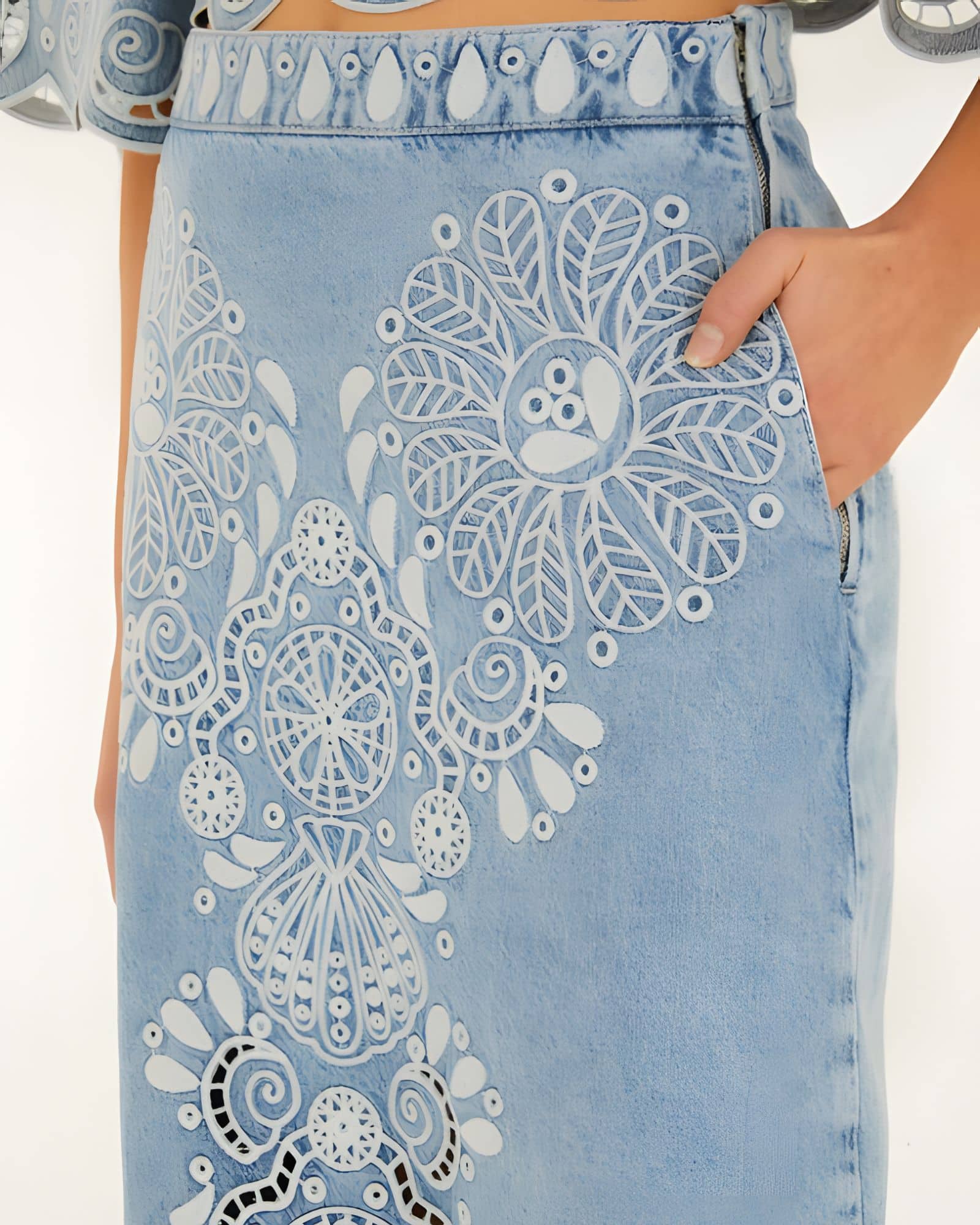 Close-up side view of the Farm Rio denim Richelieu skirt, highlighting the side pocket, zipper closure, and intricate white embroidery.