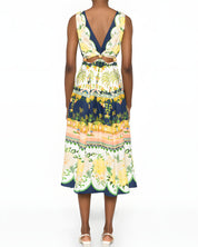 Rear studio view of a model wearing the Farm Rio embellished printed midi dress, highlighting the elegant open-back design and sleeveless cut.