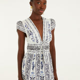 Model wearing the Farm Rio Flowers Arch ruffled mini dress