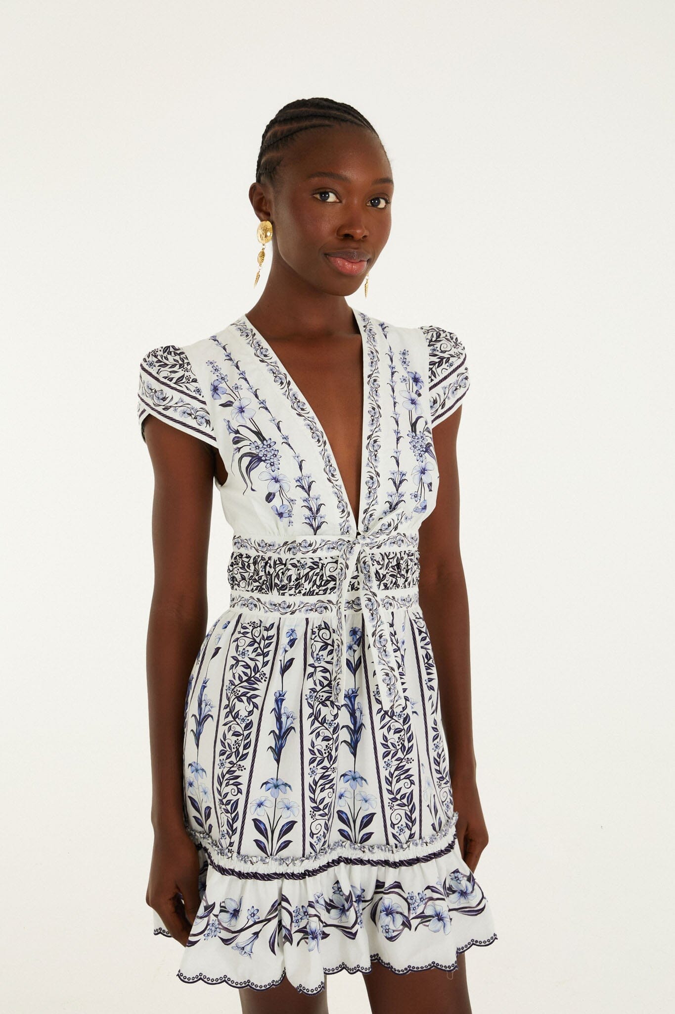 Model wearing the Farm Rio Flowers Arch ruffled mini dress