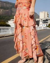 Side view of a model walking in the mocha Farm Rio floral maxi skirt, showcasing the cascading ruffled layers.