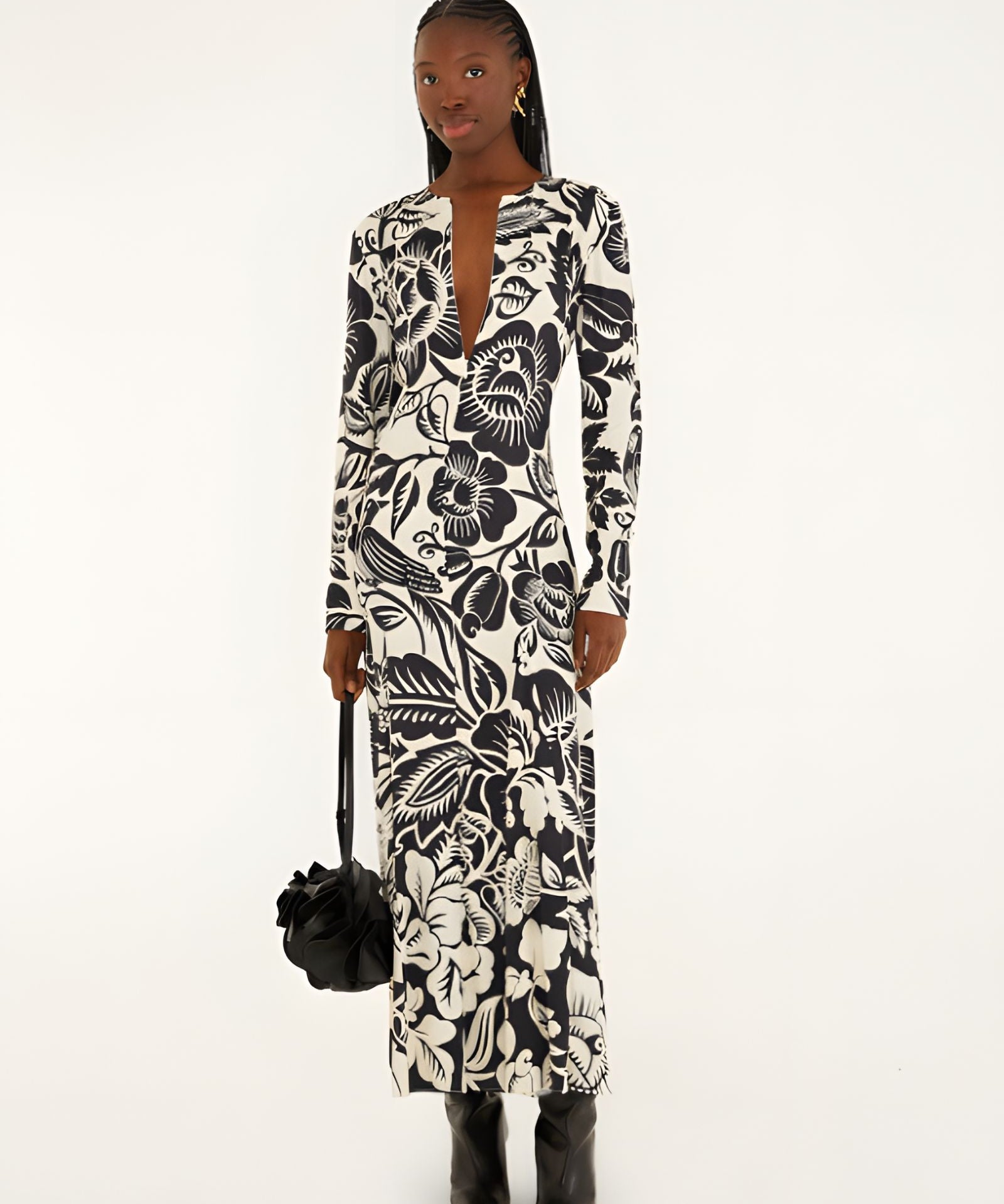 Full-length front view of a model in a studio wearing the Farm Rio Off-White Cashews and Birds viscose maxi dress with long sleeves and a bold graphic print.