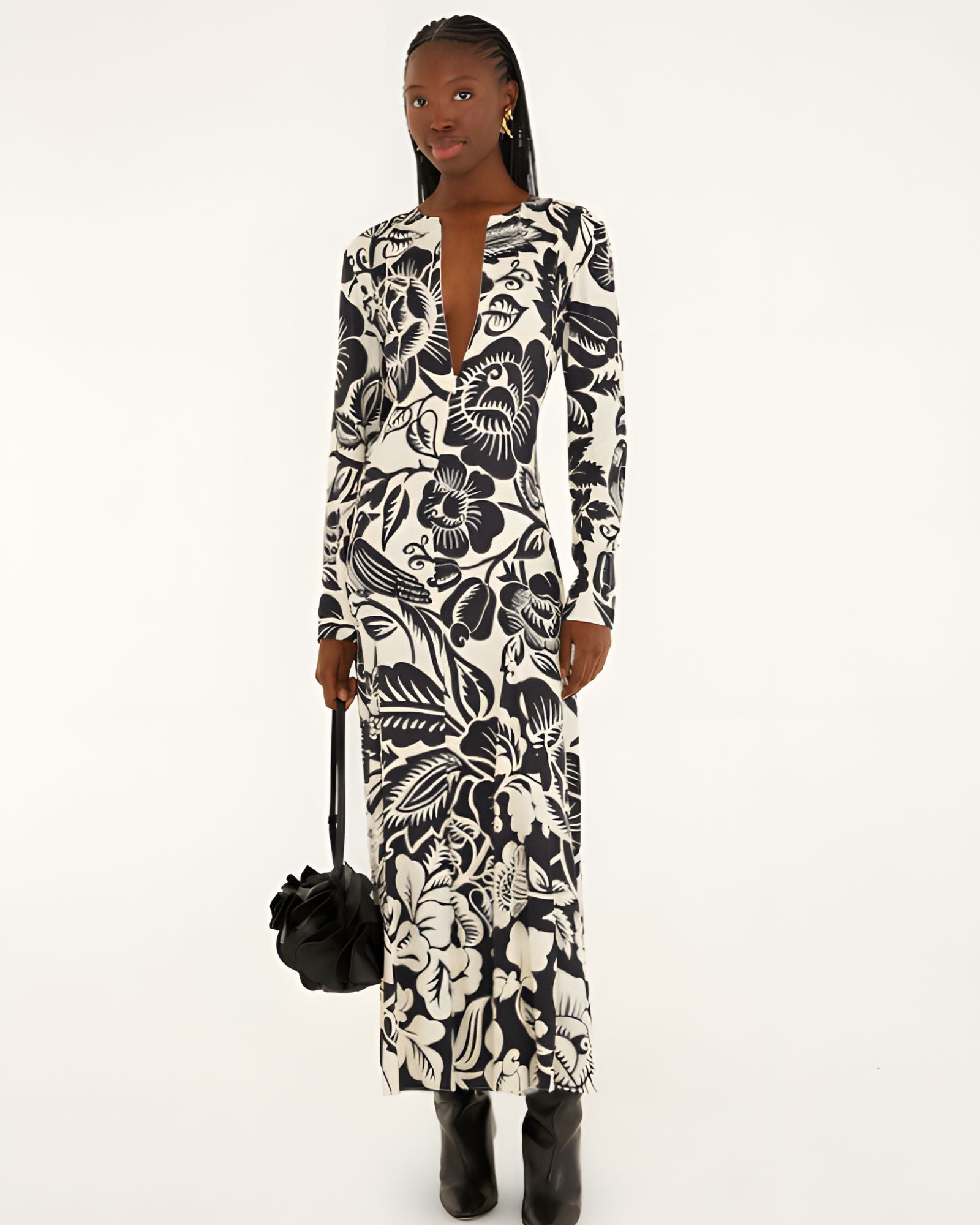 Full-length front view of a model in a studio wearing the Farm Rio Off-White Cashews and Birds viscose maxi dress with long sleeves and a bold graphic print.