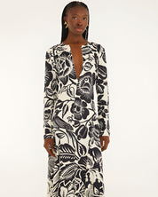 Front view of a model highlighting the sleek column silhouette and sophisticated deep V-neckline slit of the Farm Rio printed maxi dress.