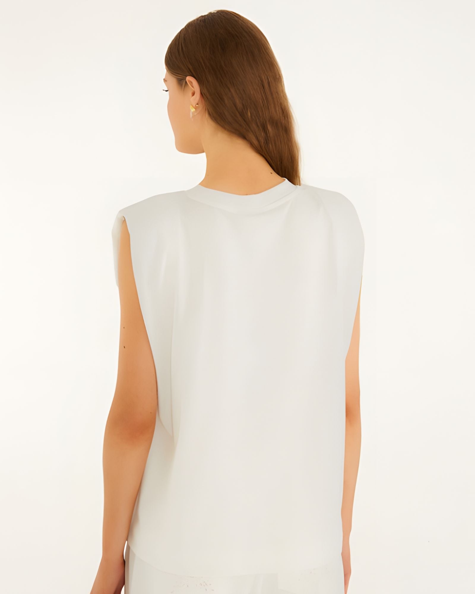 Back studio view of the Farm Rio off-white sleeveless t-shirt, showcasing the clean drape and structured padded shoulder silhouette.