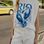 Close-up view of the Farm Rio sleeveless t-shirt, highlighting the bold blue Toucan Rio graphic print and structured shoulder padding.