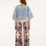 Back view of a model wearing the soft pink Farm Rio pleated maxi skirt