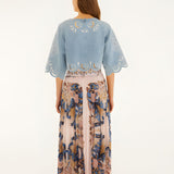 Back view of a model wearing the soft pink Farm Rio pleated maxi skirt