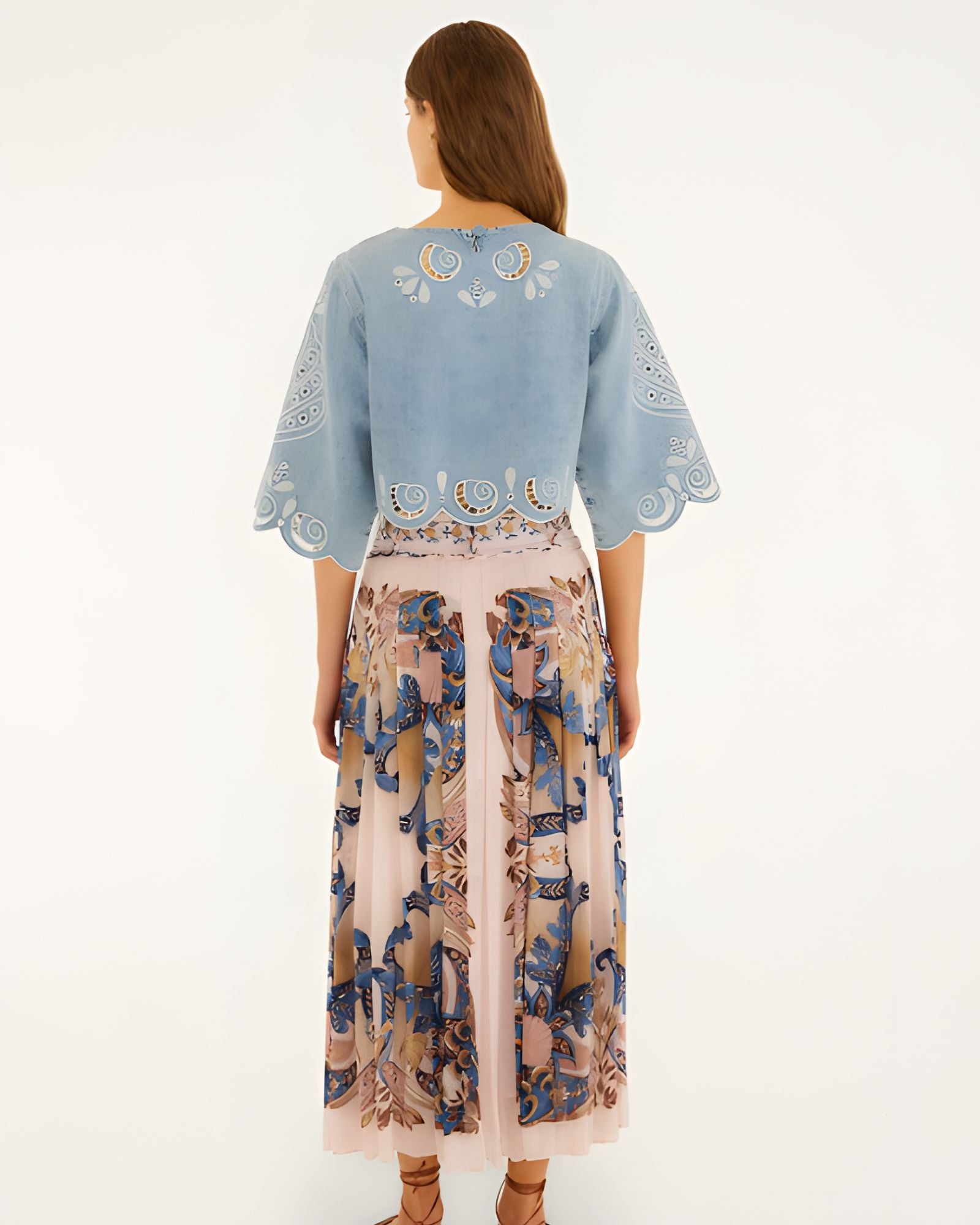 Back view of a model wearing the soft pink Farm Rio pleated maxi skirt