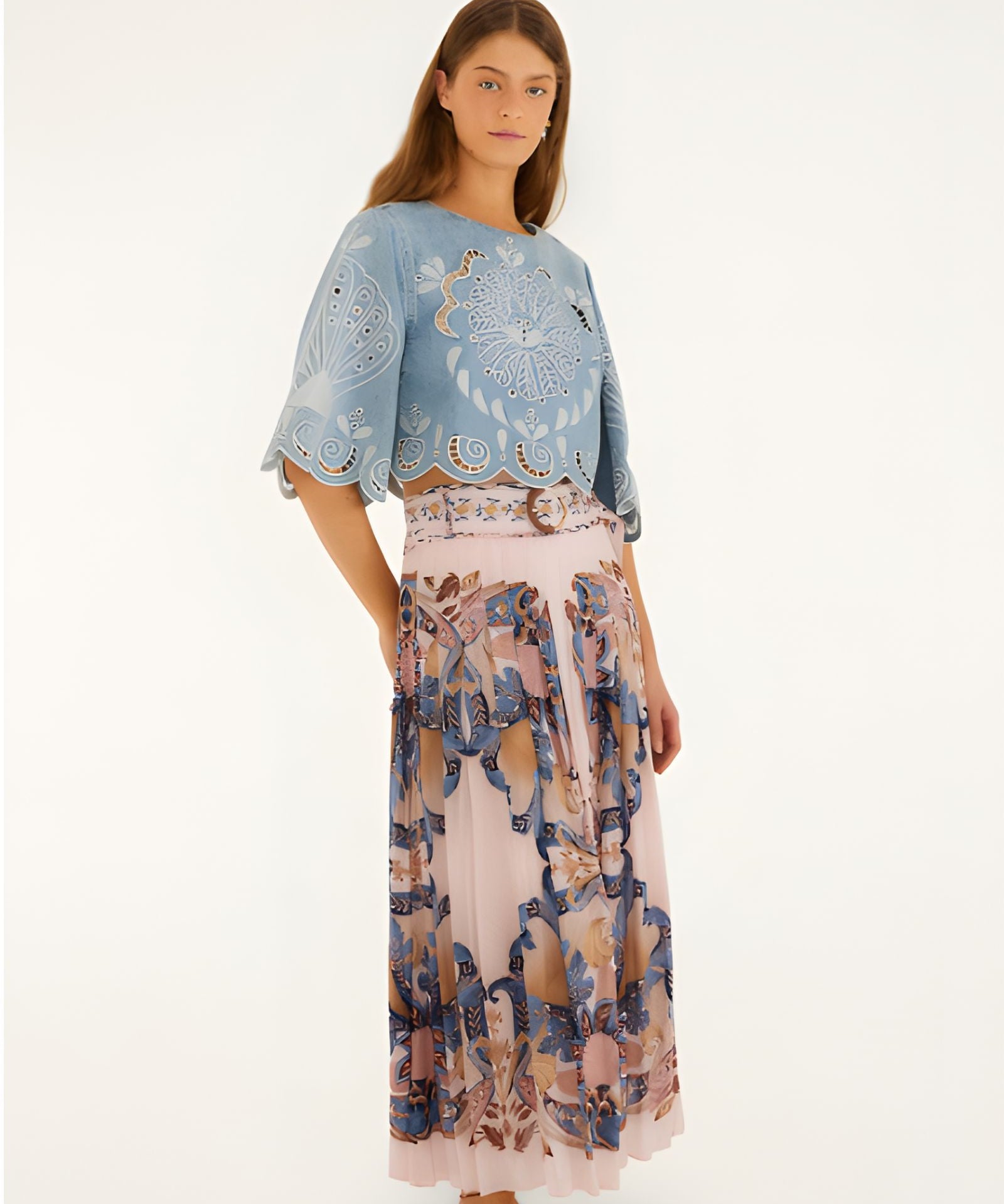 Full body view of a model styling the soft pink Farm Rio pleated maxi skirt with a blue top