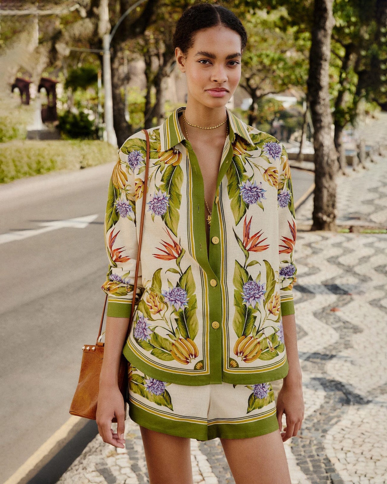 Woman wearing a floral patterned summer outfit by Farm Rio.