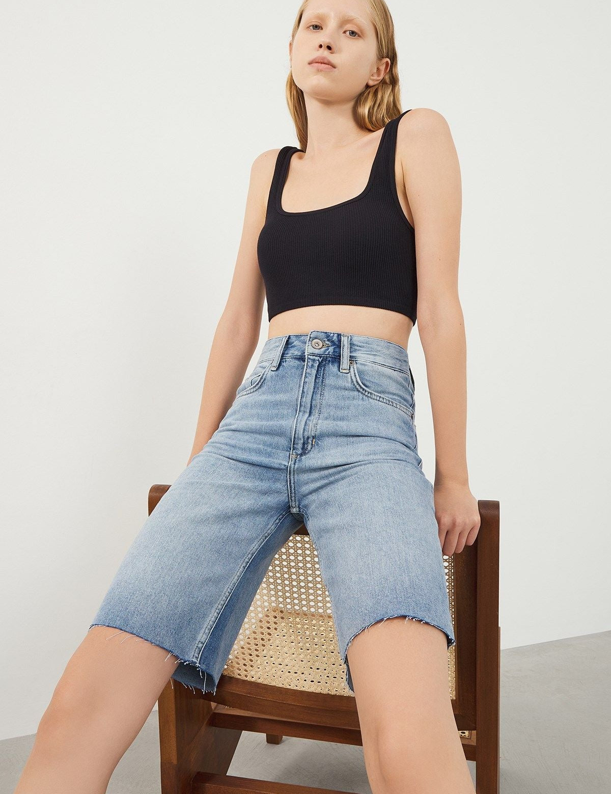 Woman wearing Vera Light Blue Denim Bermuda Shorts, front view
