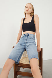 Woman wearing Vera Light Blue Denim Bermuda Shorts, front view