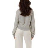 Direct back view of the grey Keila summer knit pullover, highlighting the relaxed oversize fit, dropped balloon sleeves, and fine ribbed hemline finish.