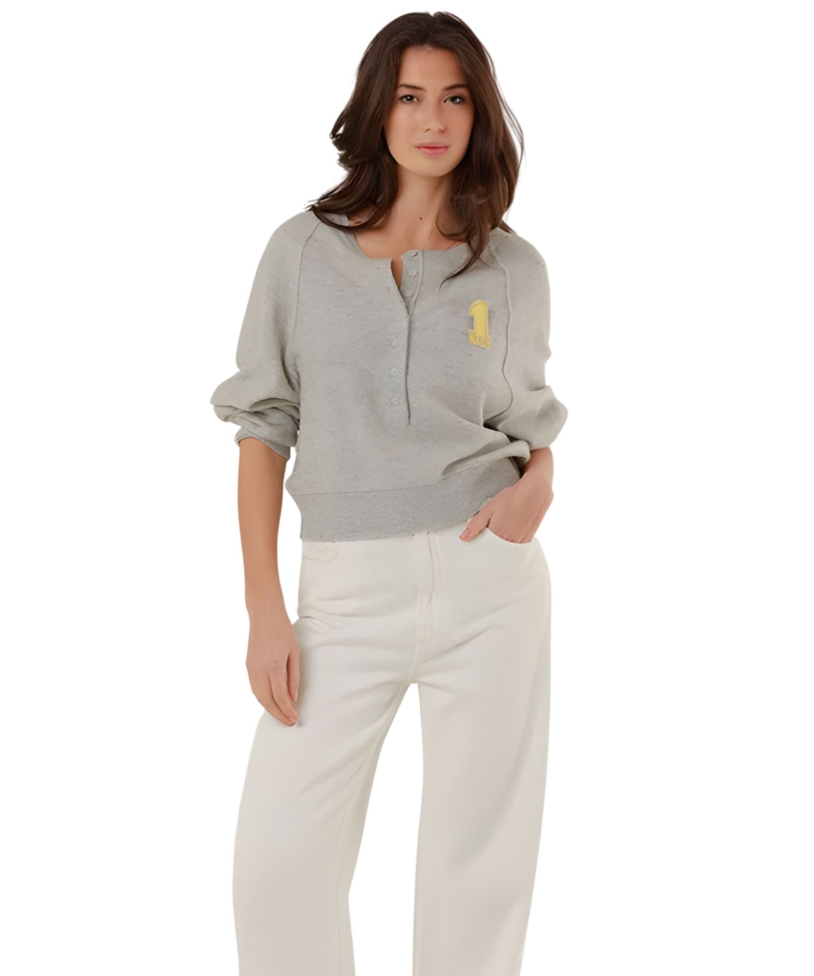 Full-length front view of a model styling the grey fine knit pullover with high-waisted white denim trousers.