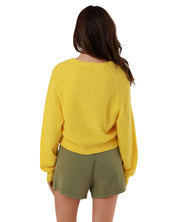 Direct back view of the yellow Keila knit pullover, showcasing the clean draped silhouette and fine ribbed hemline finish.