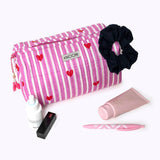 KIKOONI Love Edition pink cosmetic bag styled with a scrunchie and beauty essentials