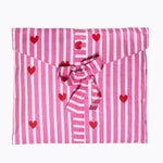 KIKOONI Love Edition pink pyjamas folded in their fabric gift bag with bow