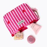 KIKOONI Love Edition pink mini pouch styled with skincare and beauty essentials