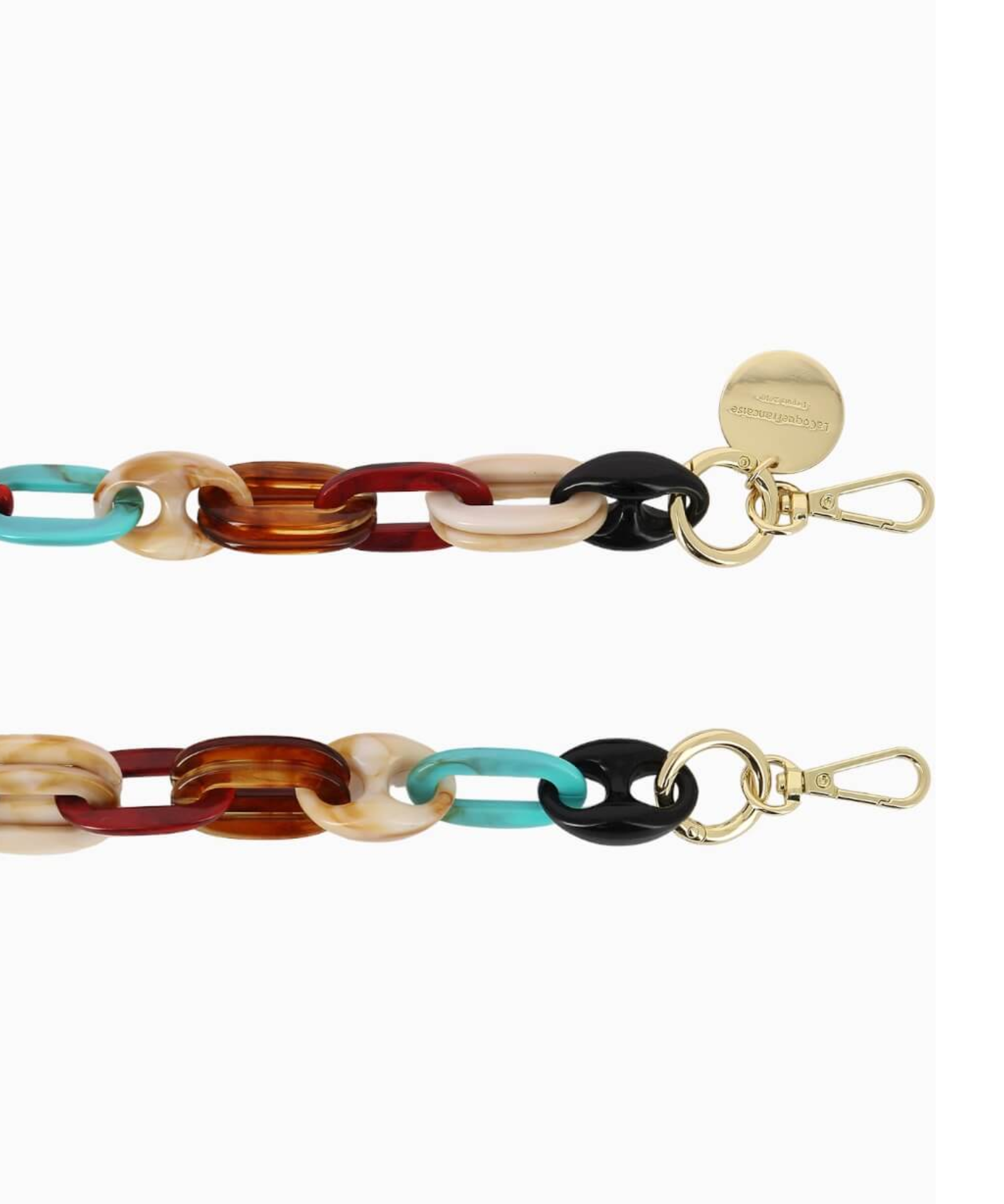 Close-up of the La Coque Française Amber phone chain showing turquoise, tortoiseshell and black resin links with gold-tone clasps.