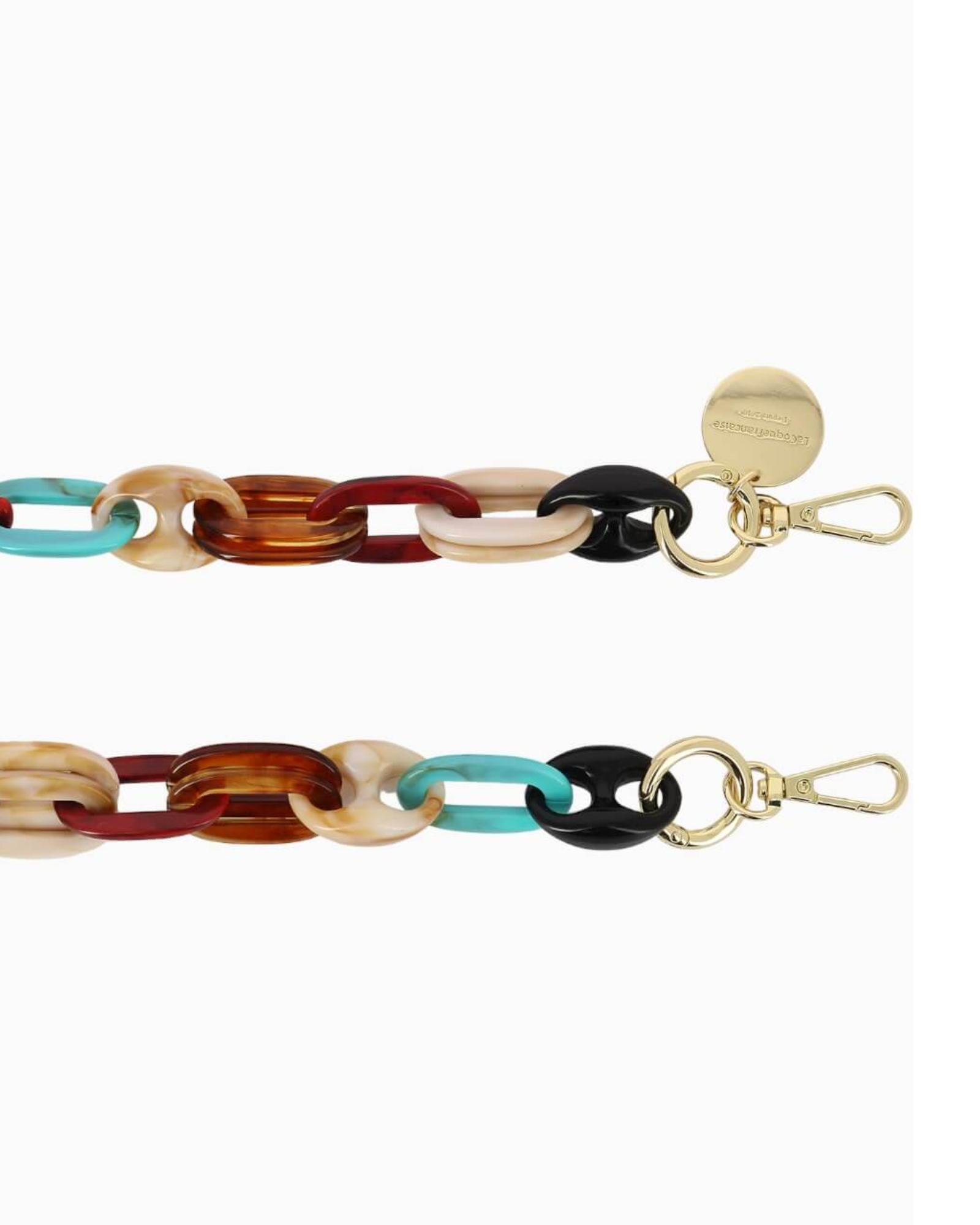 Close-up of the La Coque Française Amber phone chain showing turquoise, tortoiseshell and black resin links with gold-tone clasps.