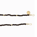 Close-up of the La Coque Française Gaby phone chain's chocolate brown wooden beads, gold-tone spacers and clasps.