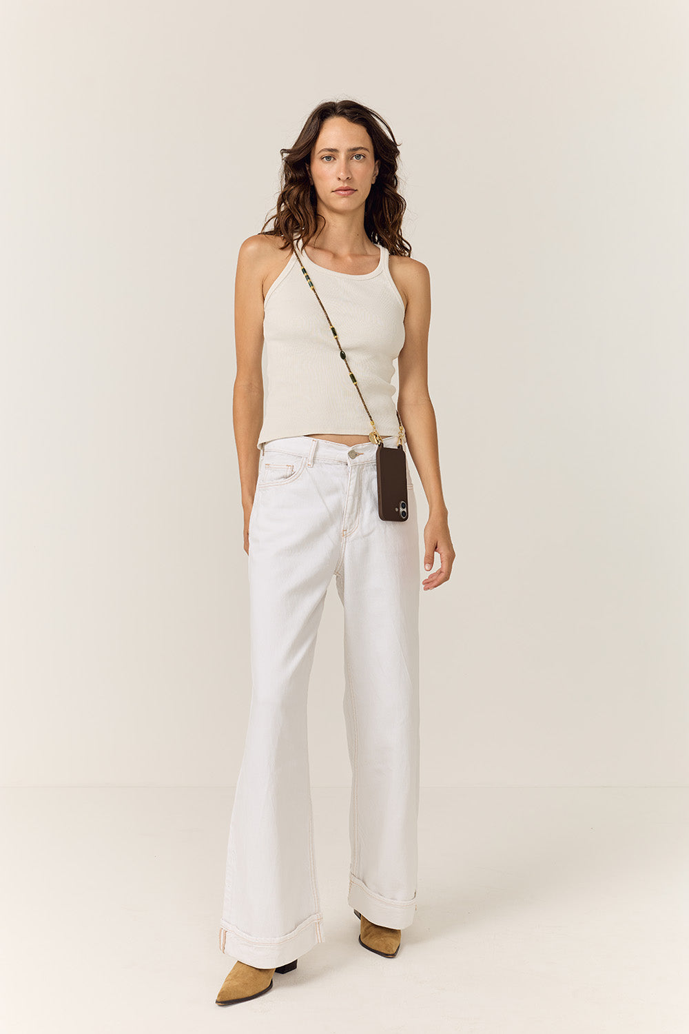 Model wearing the La Coque Française Izzie sage green beaded phone chain