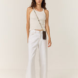 Model wearing the La Coque Française Izzie sage green beaded phone chain