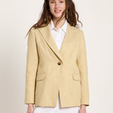 Woman wearing the relaxed-fit LANIUS khaki-creme linen blazer over a white shirt on a plain background