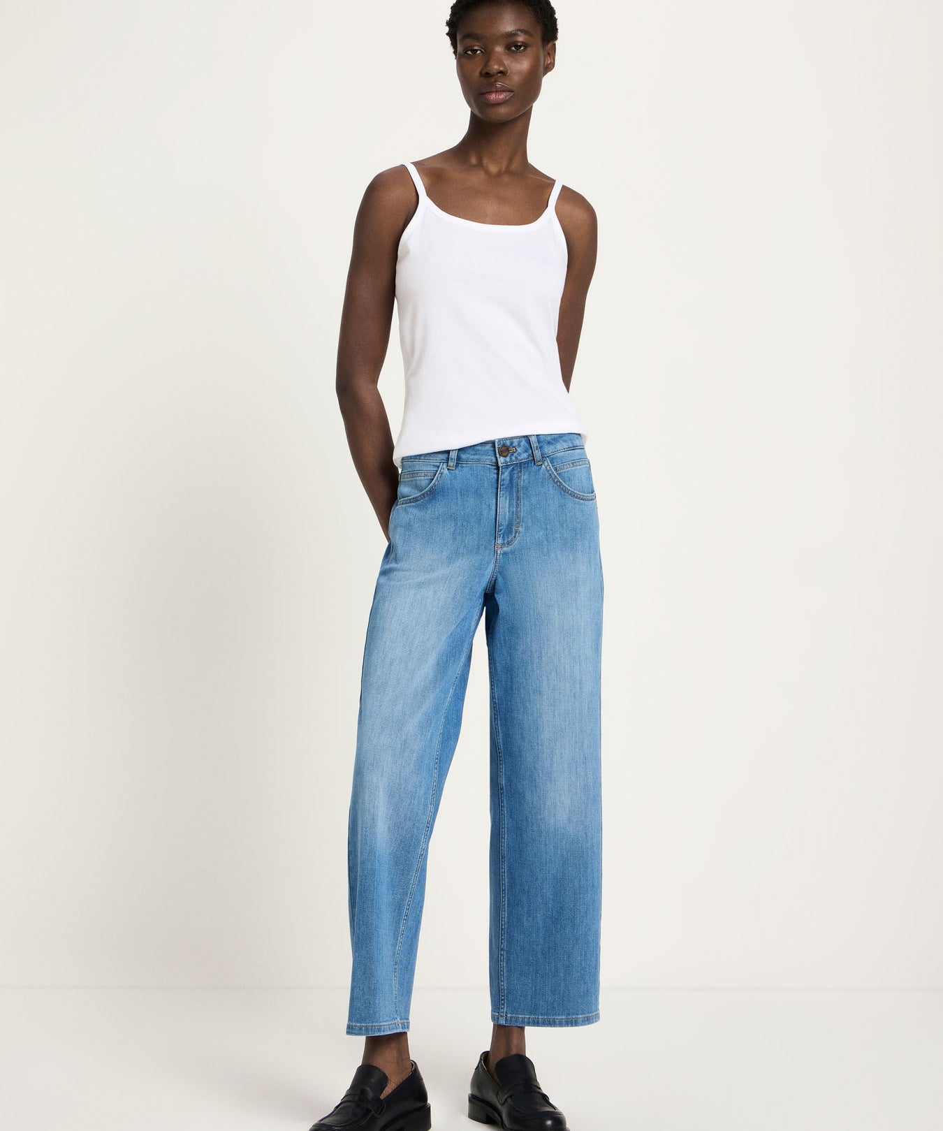 Woman wearing Lanius relaxed fit organic cotton jeans in mid blue, showing the straight wide-leg silhouette