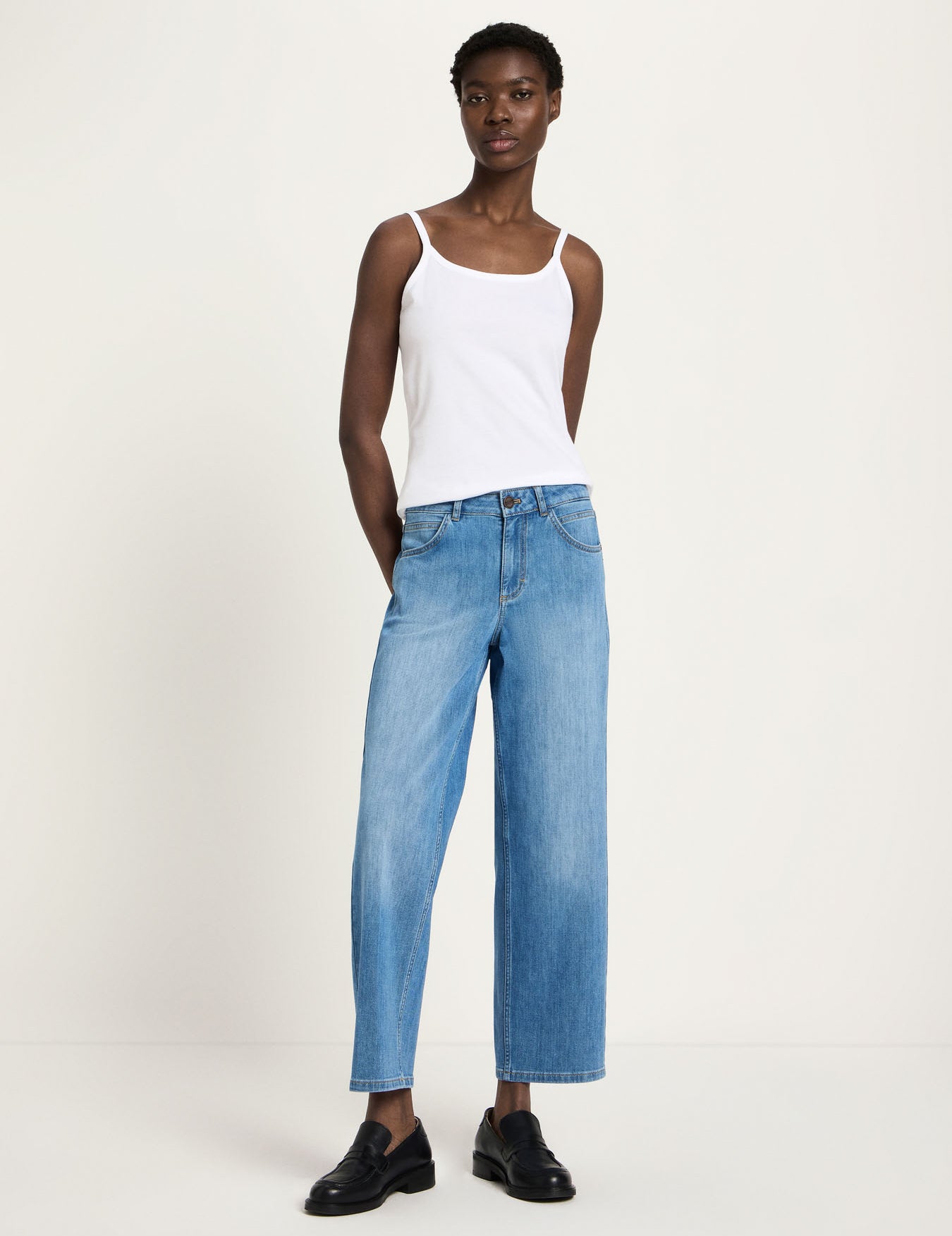 Woman wearing Lanius relaxed fit organic cotton jeans in mid blue, showing the straight wide-leg silhouette