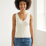 Model wearing a Lanius off-white rib knit organic cotton tank top with a V-neck, styled with blue jeans.
