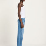 Side profile of a woman wearing Lanius cropped wide-leg jeans in blue, styled for a relaxed sustainable luxury look.