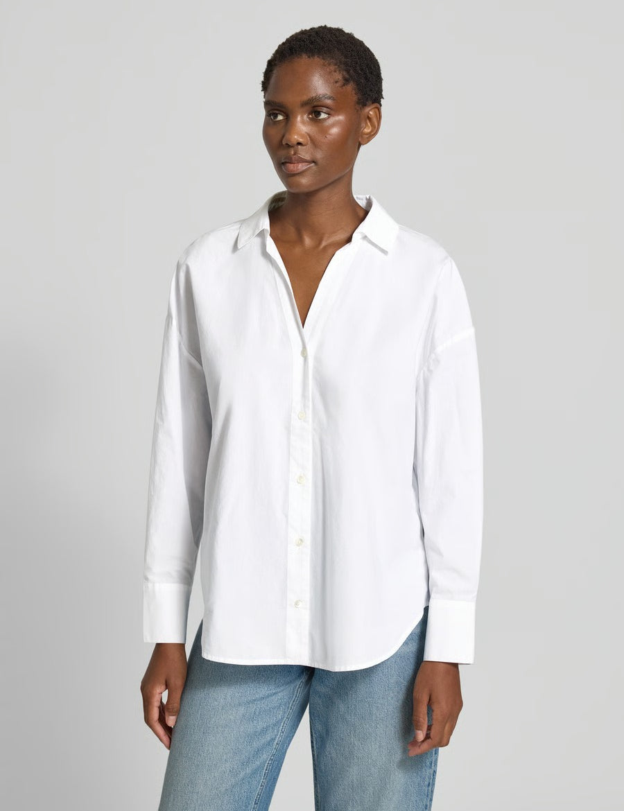 Model wearing the Lanius oversized white organic cotton shirt tucked into denim.