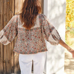 Back view of a woman outdoors wearing a Mabe Apparel bohemian printed puff sleeve cotton jacket.