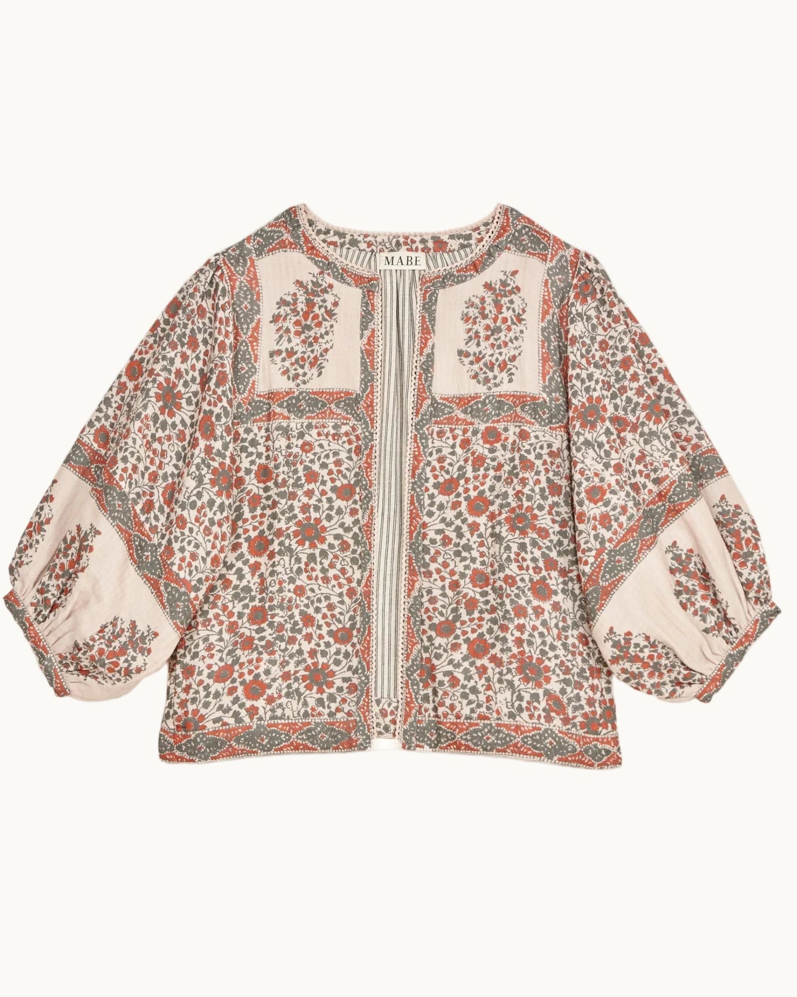 Mabe Apparel printed cotton jacket with puff sleeves in a coral red and olive green floral pattern.
