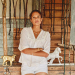 Model wearing white lace cotton blouse by Mabe Apparel in summer.