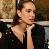 Woman with long hair wears beaded Santa Fe Earrings with a black outfit. 