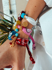 A Mediterranean summer stack of andana bracelets featuring the Aegean Blue Evil Eye. 