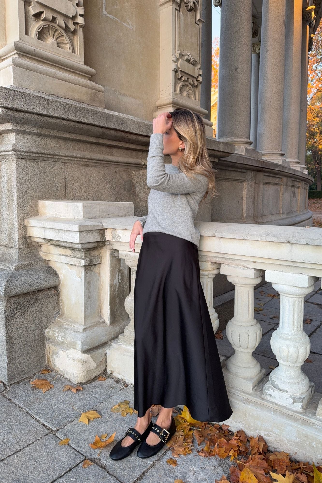 Woman wearing MICUIR Danseur de Roche black Mary Jane flats with a grey jumper and black skirt