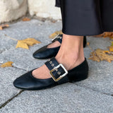MICUIR Danseur de Roche black Mary Jane flat on the foot, worn with a long satin skirt