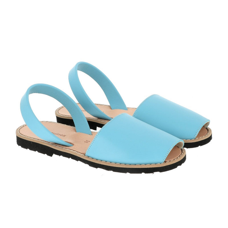 Pair of Minorquines avarca leather sandals in aquamarine blue, worn