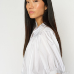 White MMTarima cotton blouse worn by model, angled side view