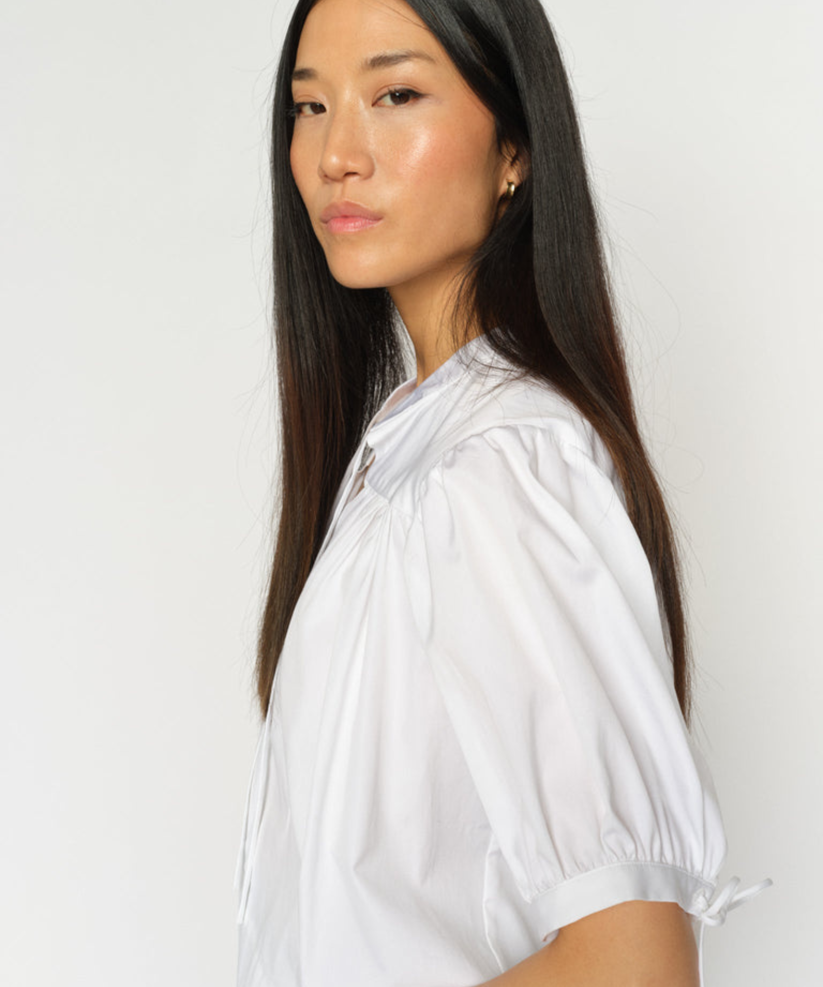 White MMTarima cotton blouse worn by model, angled side view